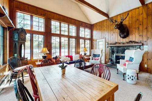 a living room with a wooden table and chairs at Moose & Red Fox Retreat in Denmark