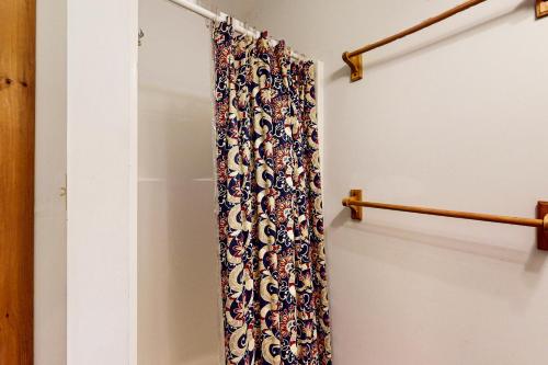 a shower curtain hanging on a rack in a room at Moose & Red Fox Retreat in Denmark