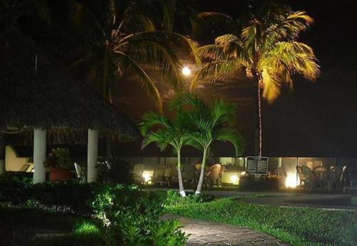 a resort at night with palm trees and lights at Playa Caracol Hotel & Spa in Veracruz