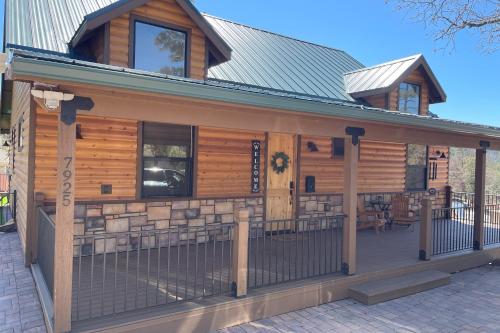 a log cabin with a fence in front of it at Sweet Strawberry Cabin in Pine