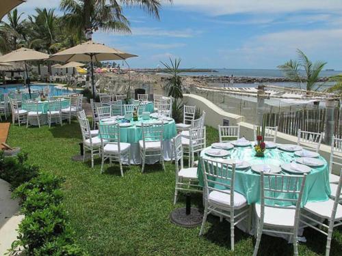 a group of tables and chairs at a resort at Playa Caracol Hotel & Spa in Veracruz