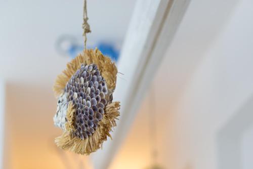 a bird ornament hanging from a window at ControVento Rooms in Margherita di Savoia