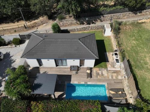 an overhead view of a house with a swimming pool at Villa De Charme T3 Saint Florent in Barbaggio