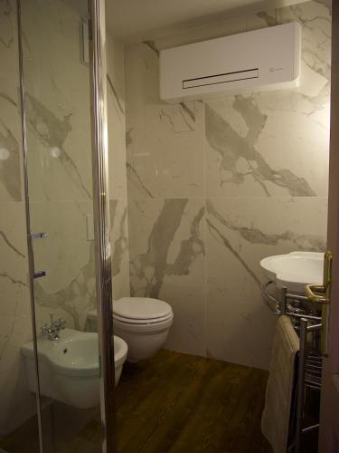 a bathroom with a toilet and a sink at Villa San Liberale - Suites & Wellness - Villa Veneta in Feltre