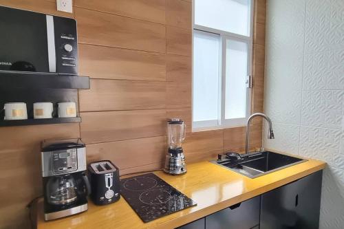 a kitchen with a counter with a blender and a sink at Viñedito del coyote, Coyoacán in Mexico City