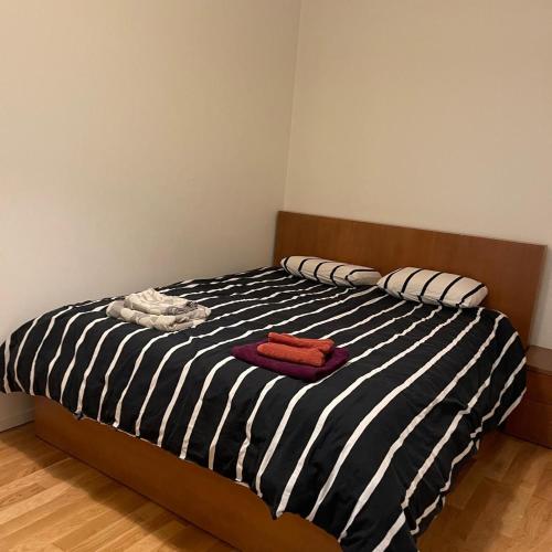 a bedroom with a black and white striped bed at Engen 6 in Bergen