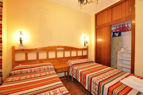 Ένα ή περισσότερα κρεβάτια σε δωμάτιο στο Apartamentos Tao