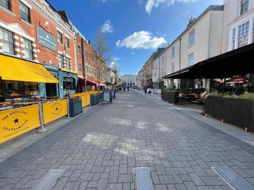 an empty street in a city with buildings at John Street Stays in Southampton