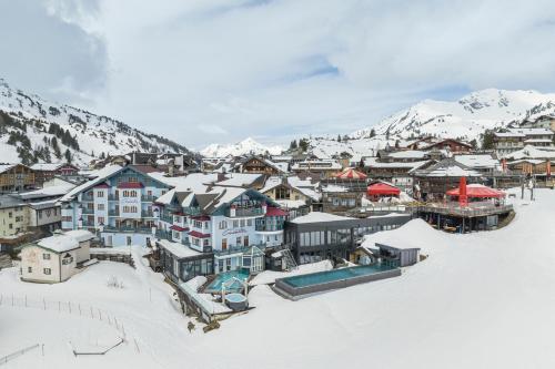 a town covered in snow with mountains in the background at Sporthotel Cinderella in Obertauern
