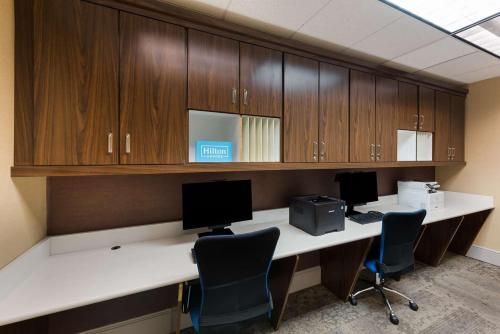 an office with two desks with computers and cabinets at The Hilton Garden Inn in Grove City