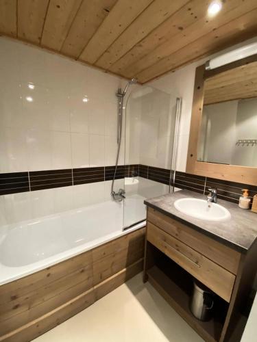 une salle de bain avec une baignoire blanche et un lavabo dans l'établissement Résidence Antares - Joli T2 à Risoul près des pistes dans résidence avec piscine/spa MAE-3841, à Risoul