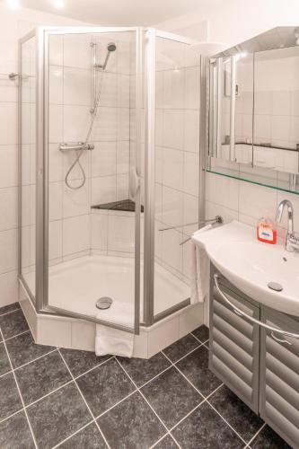a bathroom with a shower and a sink at Alan Apartment in Kaprun SOMMER CARD - Amazing view - Central Location in Kaprun