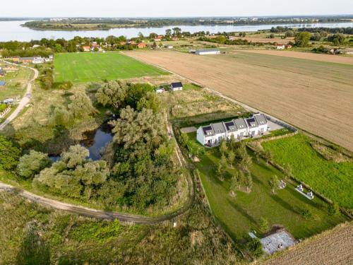 an aerial view of a house and a field at Domki Ostoja - nad Bałtykiem - cisza i piękno natury in Zastań