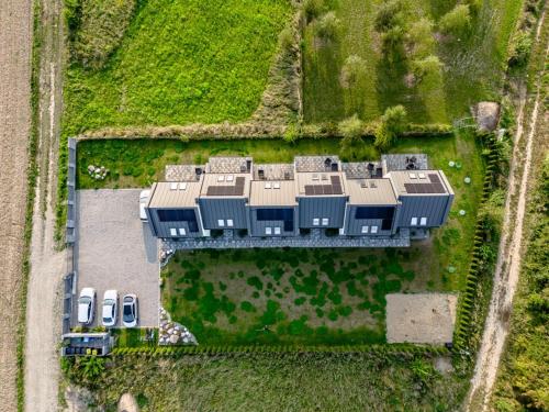 an aerial view of a farm with several buildings at Domki Ostoja - nad Bałtykiem - cisza i piękno natury in Zastań