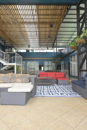 a room with couches and chairs in a building at Hotel Las Colinas in Fortuna