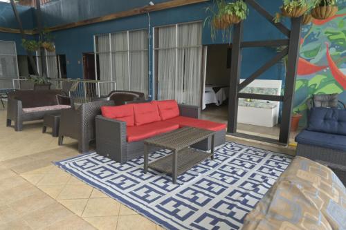 a living room with a couch and a table at Hotel Las Colinas in Fortuna