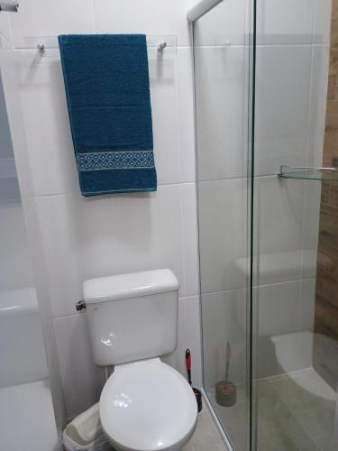 a bathroom with a toilet and a glass shower at Kitnet no interior de São Paulo in Serra Negra