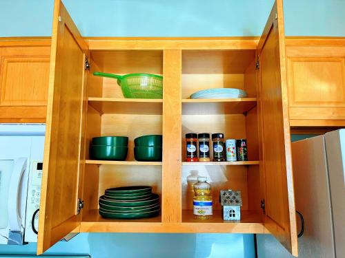 a wooden cabinet with plates and dishes in it at Whiskey Run Cabin, Spectacular Mountain Views in Bryson City