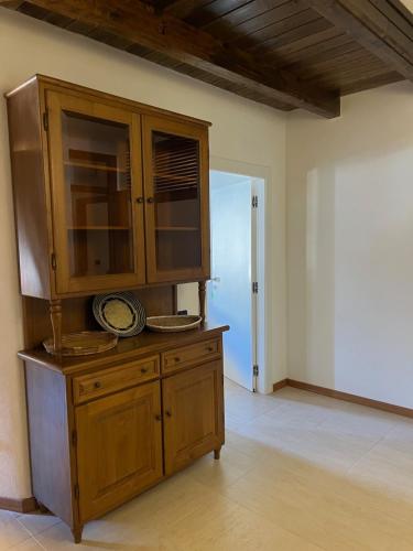 a large wooden cabinet in a room at Casa Ziranu Sa Domo e su Cantaru in Orani