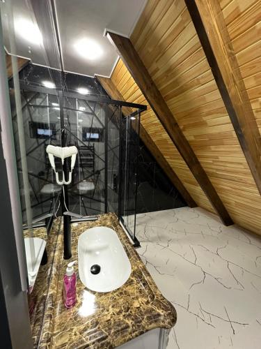 a bathroom with a sink in a attic at Qafqaz Cabana Chalet in Gabala