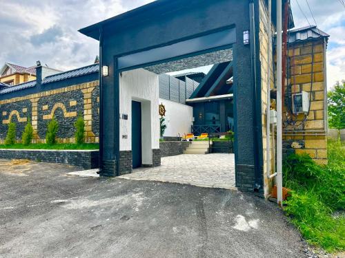 a blue and white building with an open door at Qafqaz Cabana Chalet in Gabala