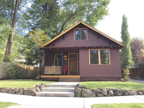 a purple tiny house with a porch at Bluebird Day - Cinder Cone Bungalow in Bend