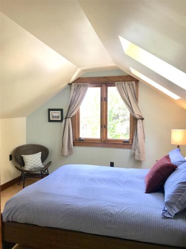a bedroom with a large bed and a window at Bluebird Day - Cinder Cone Bungalow in Bend