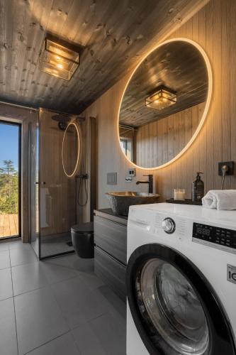 a washing machine in a bathroom with a mirror at Stryn Wiew Logde Tverrfjellet in Stryn