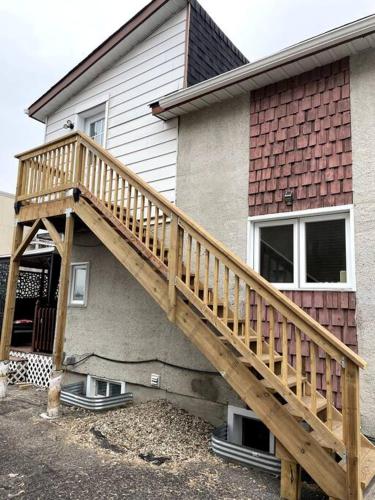 a wooden staircase leading up to a house at The Mini Apartment on Richer in Gatineau