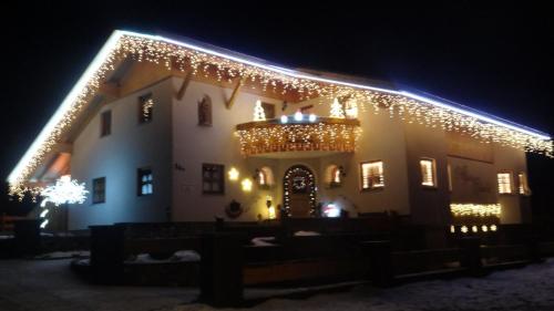 a building with christmas lights on it at night at Alpen-Chalet Ehrwald in Ehrwald