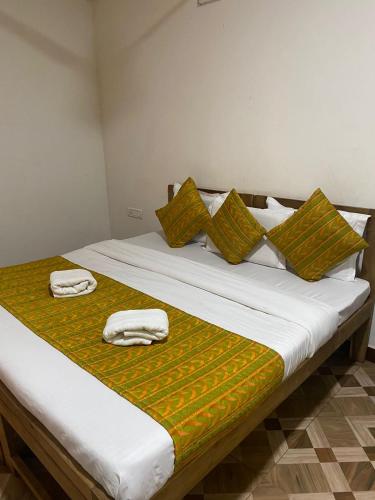 a bed with two towels sitting on top of it at Calangute Sea Avenue in Calangute