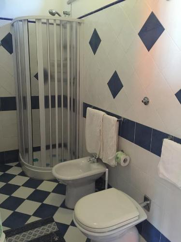a bathroom with a toilet and a shower at Holiday Home Gionny & Mary in Taormina