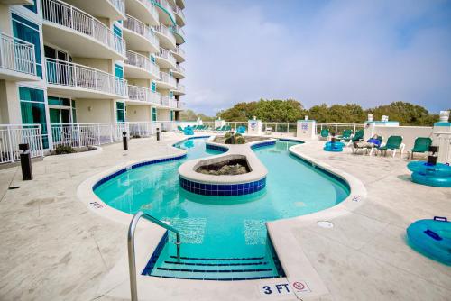 a pool at a resort with a swimming pool at The Horizon at 77th in Myrtle Beach