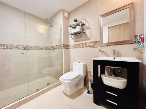 a bathroom with a toilet and a sink and a shower at Cancún Bella & Vista Apartment in Cancún