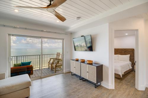 a bedroom with a bed and a balcony with the ocean at Florida Keys Getaway with Stunning Ocean Views in Layton