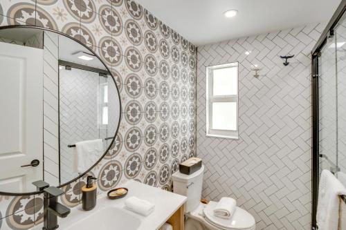 a bathroom with a sink and a mirror and a toilet at Florida Keys Getaway with Stunning Ocean Views in Layton
