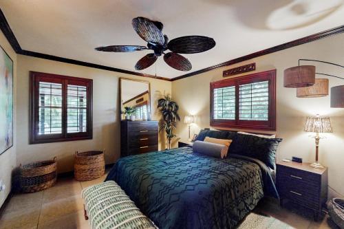 ein Schlafzimmer mit einem Bett und einem Deckenventilator in der Unterkunft Coastal Paradise Getaway in Cape Coral