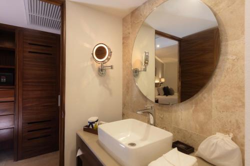 a bathroom with a sink and a mirror at Buenaventura Grand Hotel & Great Moments - All Inclusive in Puerto Vallarta