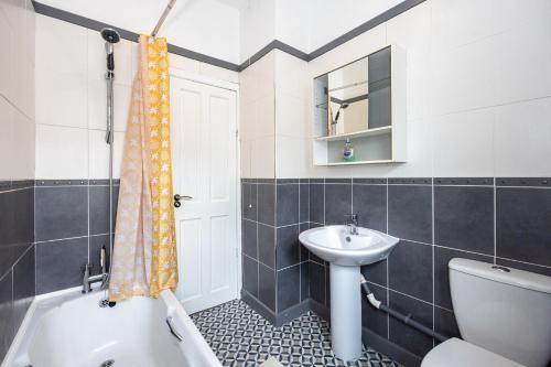a bathroom with a sink and a toilet and a shower at Manor Terrace Retreat in Accrington