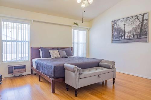 a bedroom with a bed and a chair in it at Modern House with Office Cornhole Near Freeways in Chandler