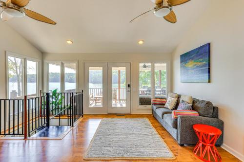 a living room with a couch and a table at Lewis Smith Lake Retreat with Dock and Deck! in Logan