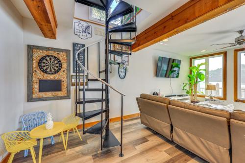 a room with a loft bed and a couch and a table at Lewis Smith Lake Retreat with Dock and Deck! in Logan