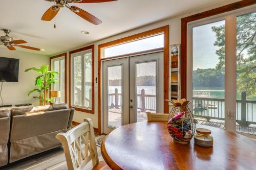 a living room with a table and a couch at Lewis Smith Lake Retreat with Dock and Deck! in Logan