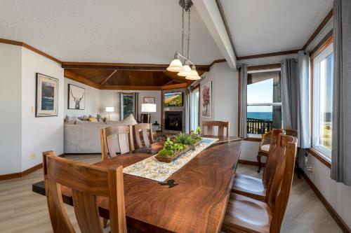 a dining room and living room with a table and chairs at Little Creek Cove Beach Resort in Newport