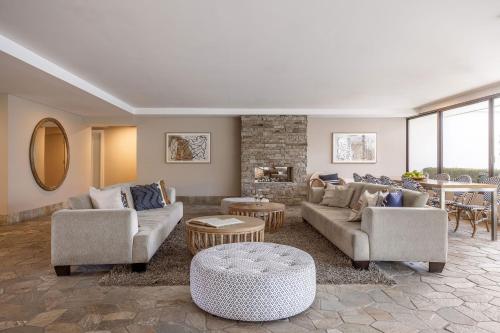 a living room with two couches and a fireplace at Waves Byron Bay in Byron Bay
