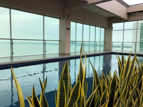 an indoor pool in a building with large windows at Apartments Puerto Santa Ana in Guayaquil