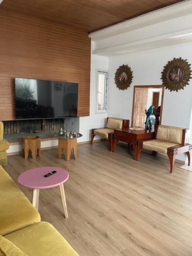 a living room with a large flat screen tv at Villa de jasmine hammamet in Hammamet Nord