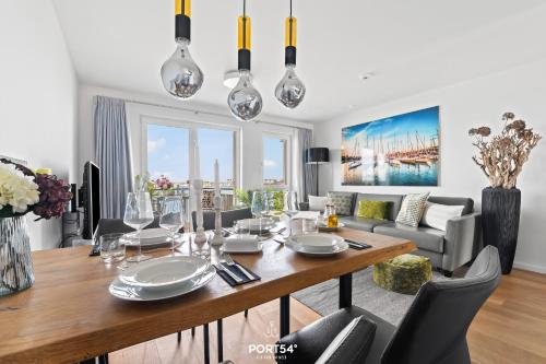 a dining room and living room with a table and chairs at Ferienwohnung Harbour Side, App 7 Olpenitz in Olpenitz