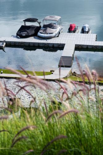 two boats are docked at a dock on the water at Tau House in Guatapé
