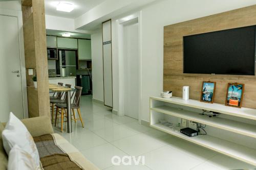 a living room with a television on a wall at In Mare Bali Resort Beira Mar by Qavi - 109 in Parnamirim
